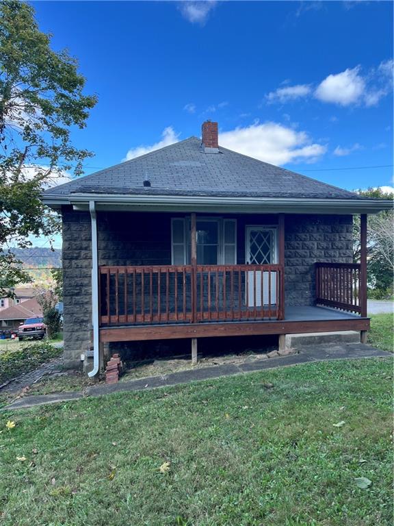 a view of a house with a yard and a deck