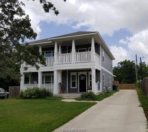 View of front facade with a balcony, a porch, and