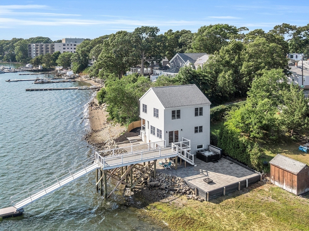 a view of house with yard outdoor seating and lake view