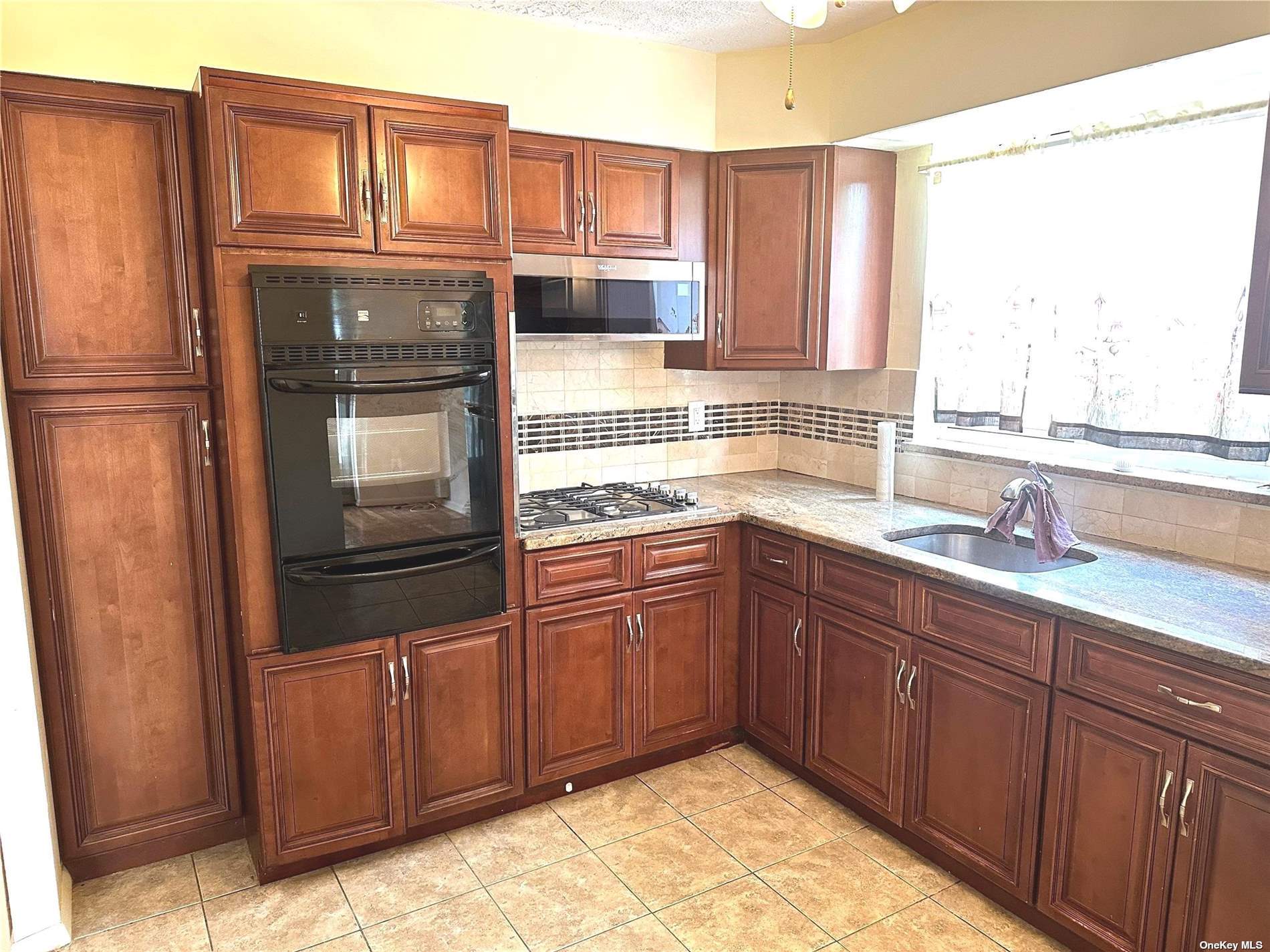 a kitchen with stainless steel appliances granite countertop a refrigerator and sink