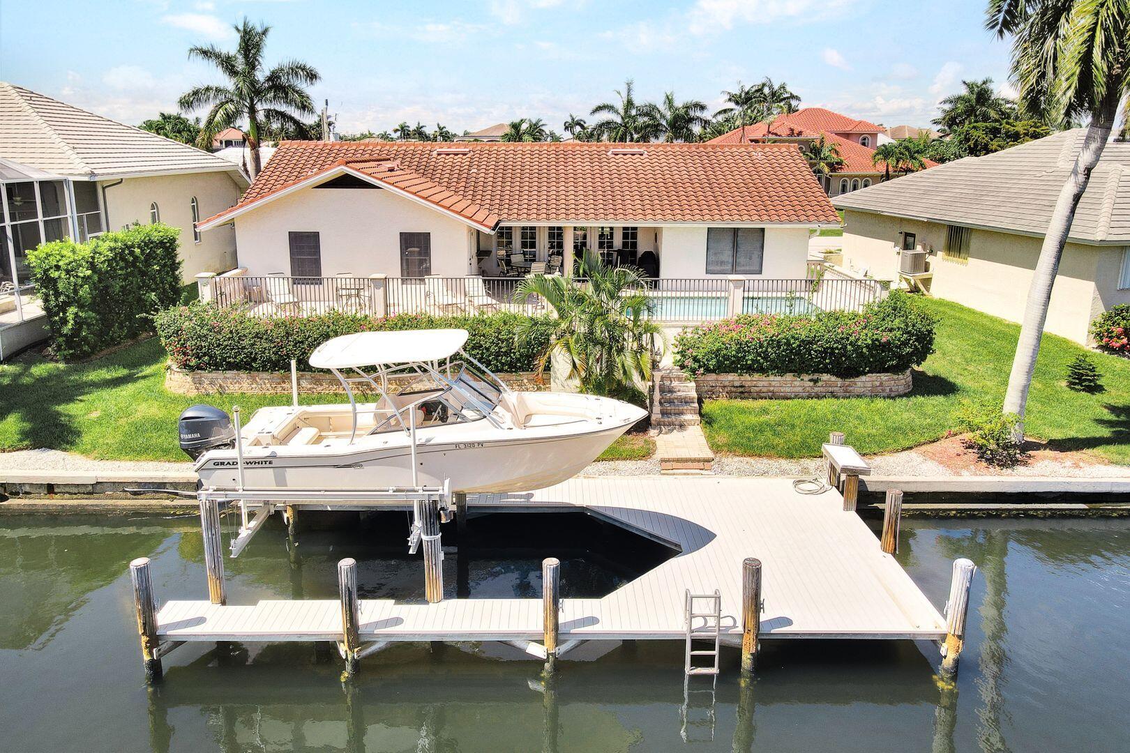 a view of house with swimming pool yard and outdoor seating