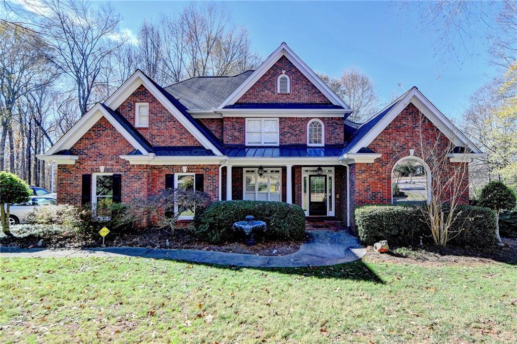 a front view of a house with a yard and porch