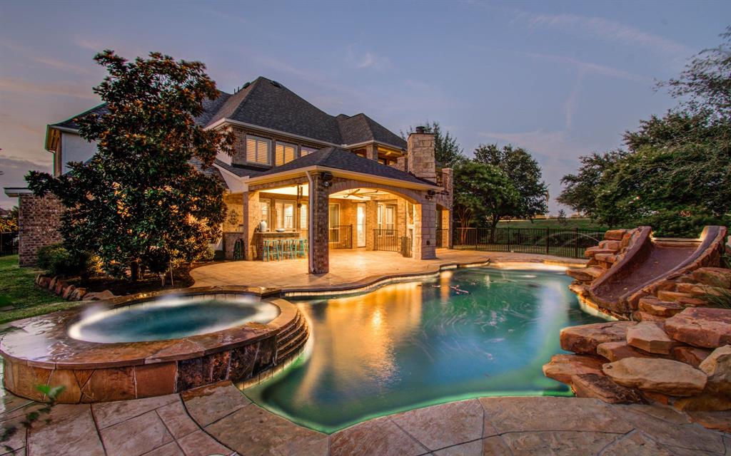 Backyard oasis with pool, hot tub and slide. 