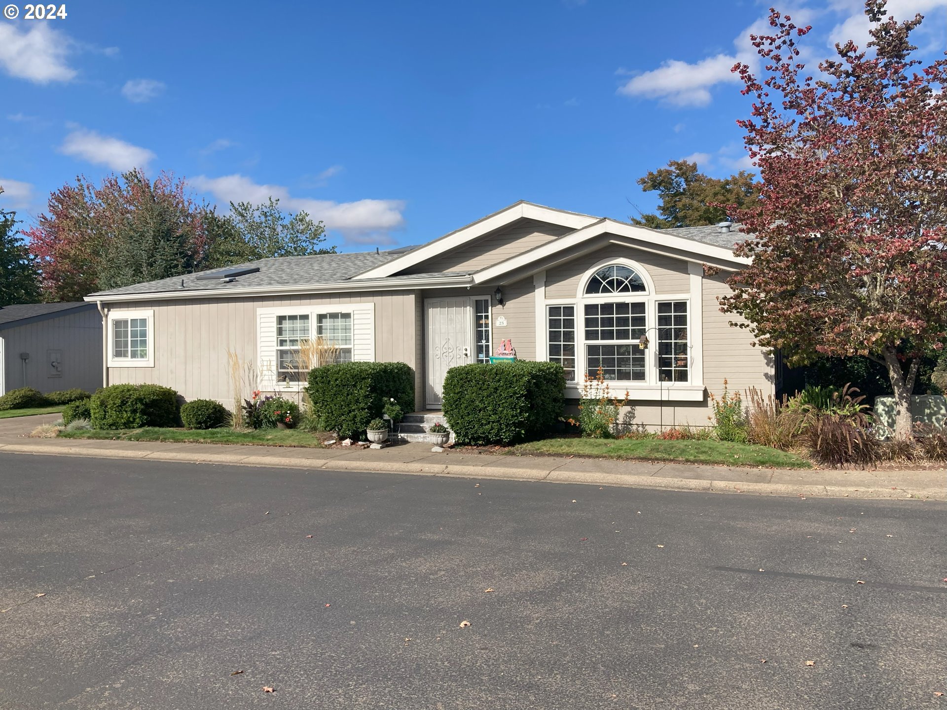 a front view of a house with a garden