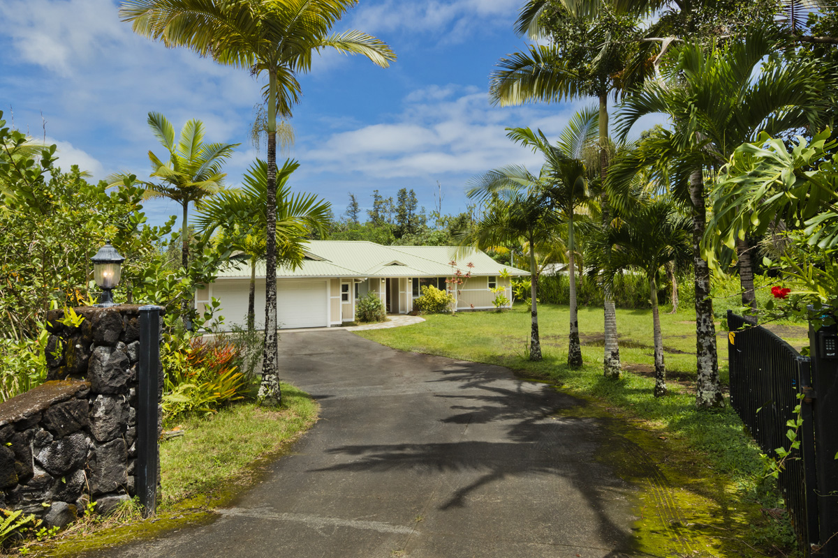 a view of a house with a yard and tree s