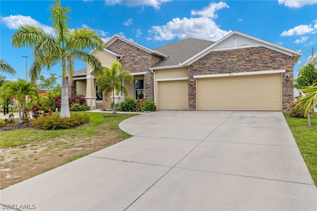 front view of a house with a yard and palm trees