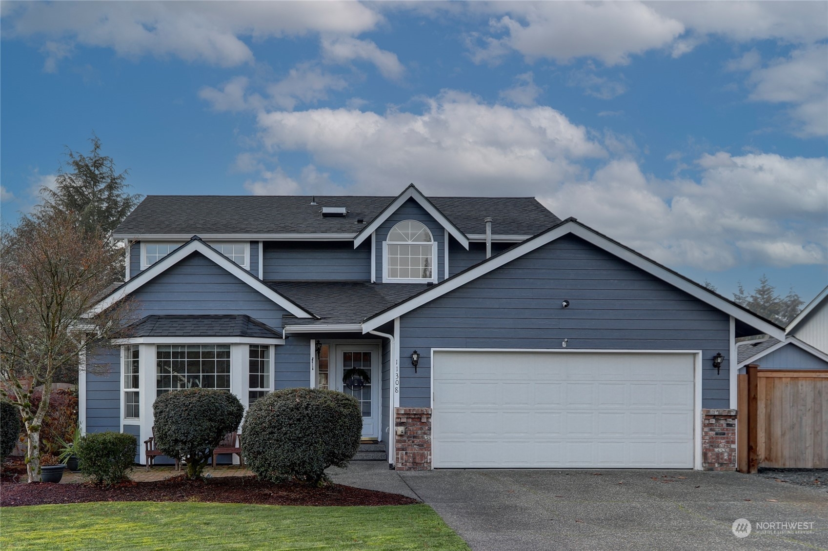 a front view of a house with a yard and garage