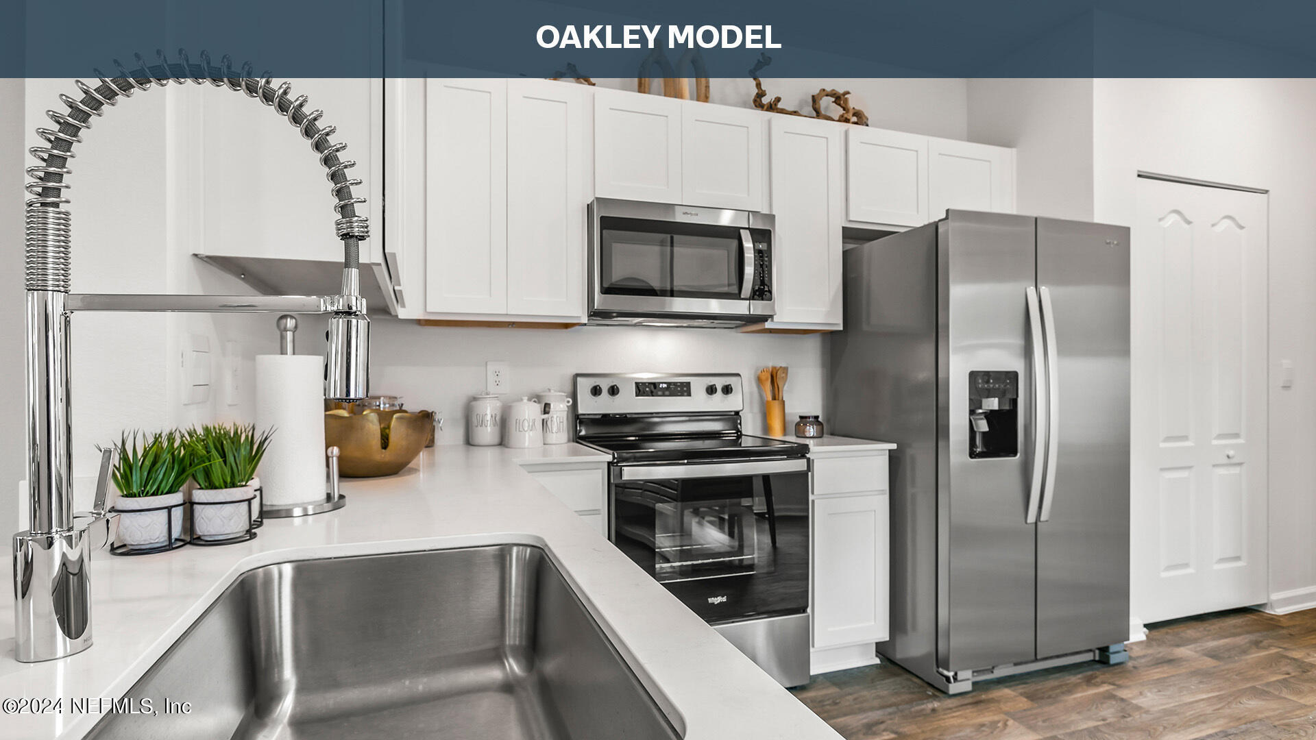 a kitchen with stainless steel appliances a microwave a sink and a refrigerator