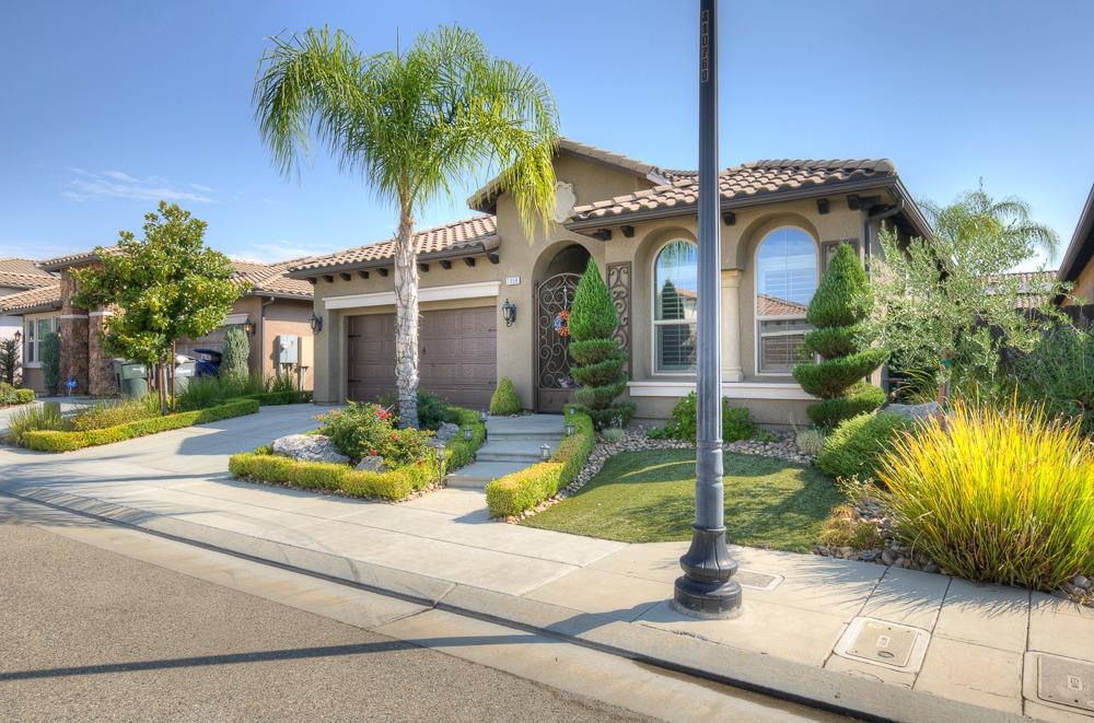 a front view of a house with yard and swimming pool