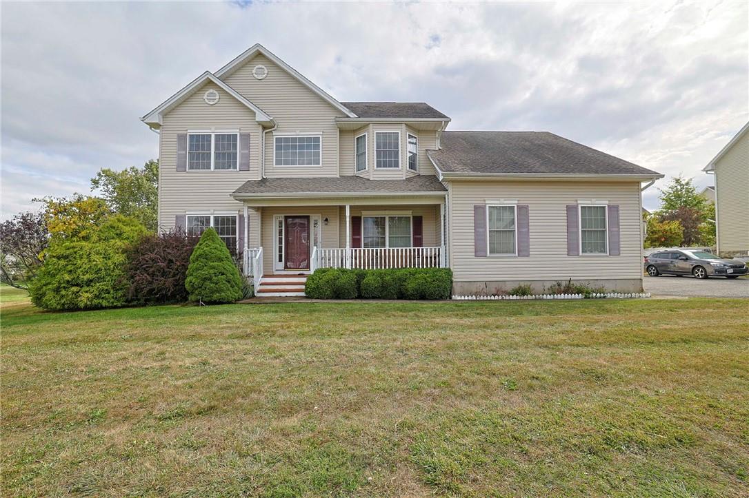 View of front of home featuring a front lawn and covered porch