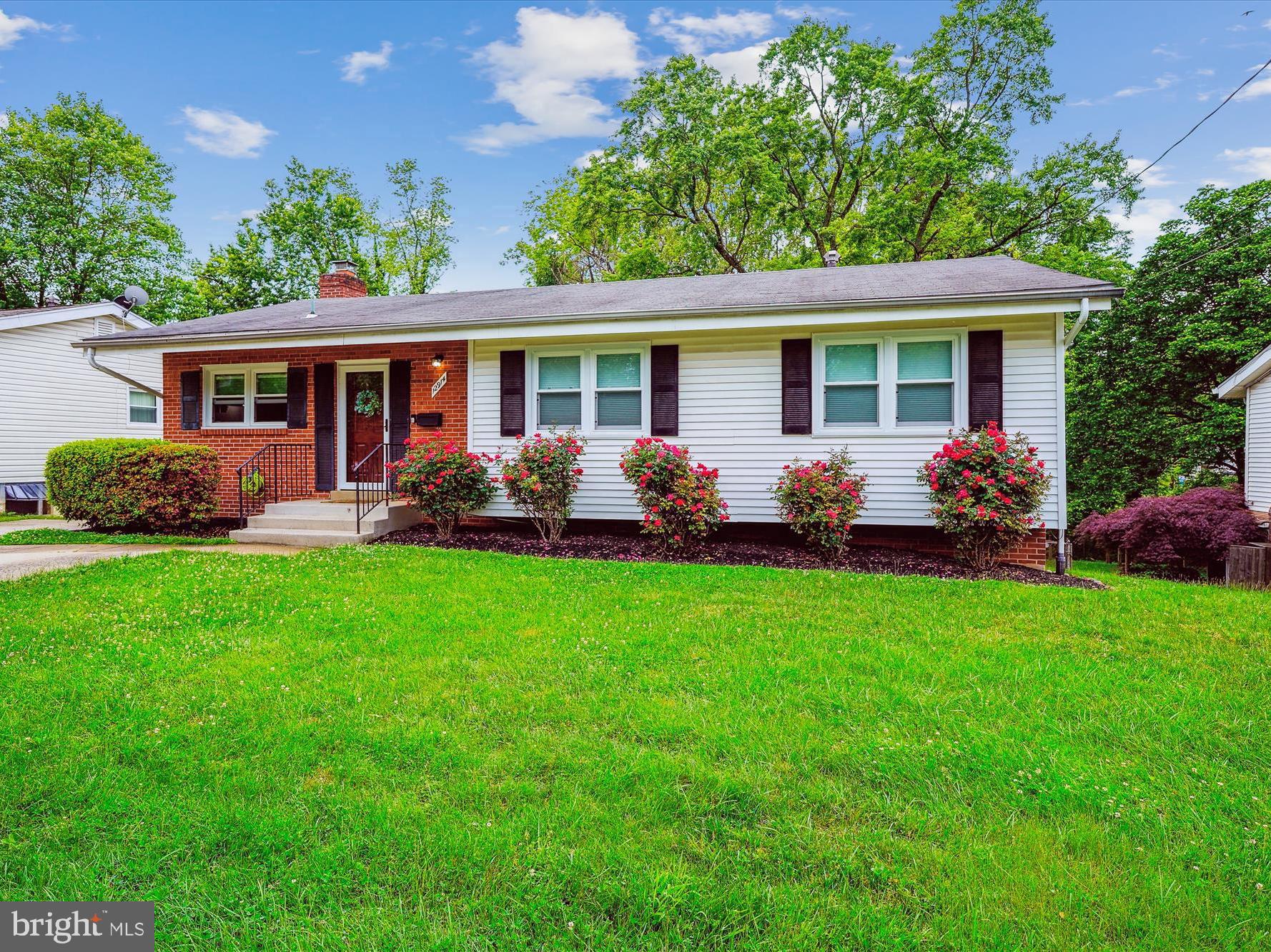 a front view of house with yard seating and green space