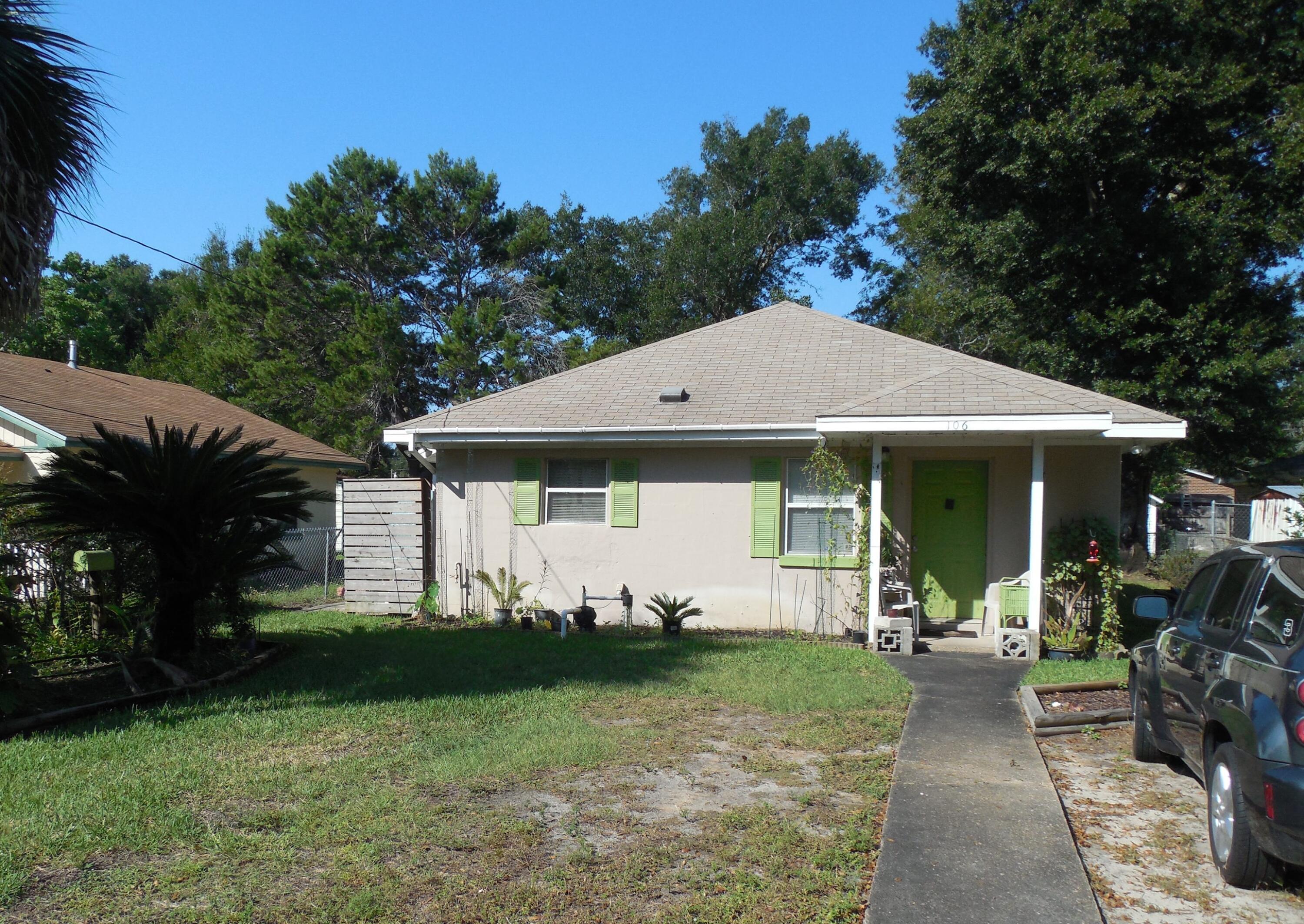 a view of a house with yard and a garden