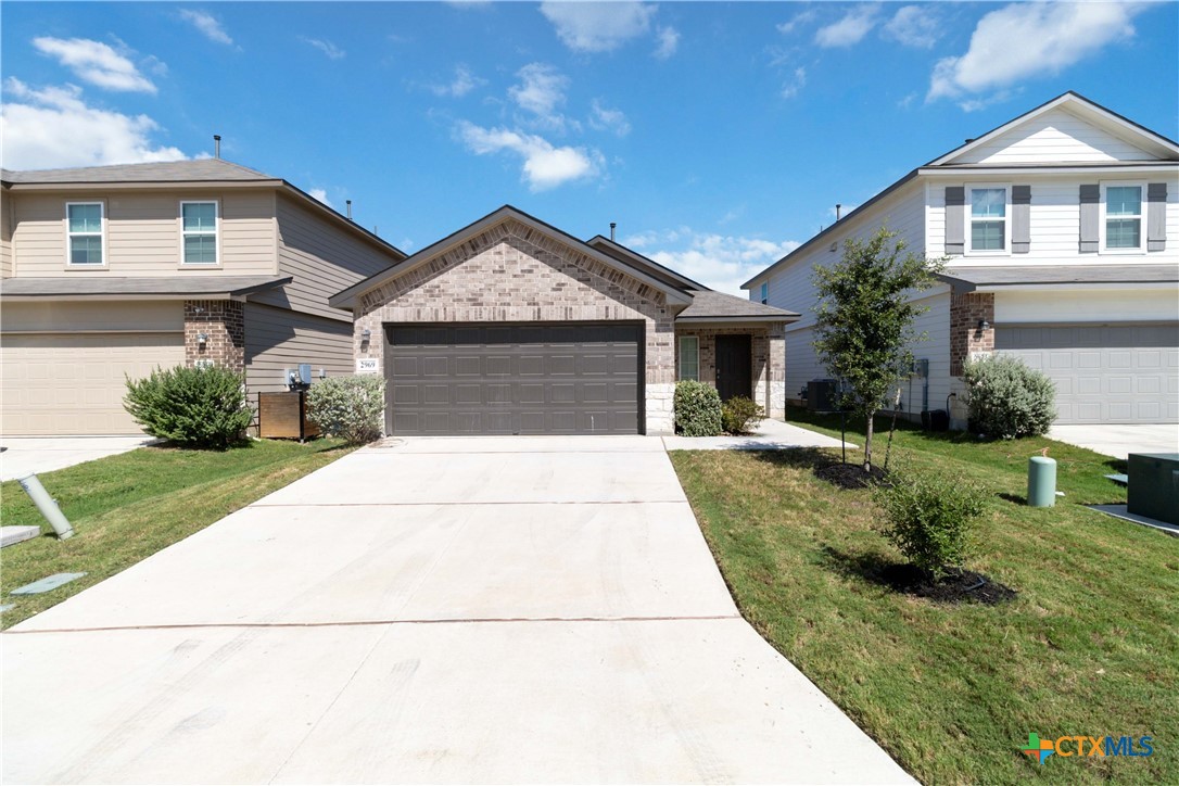 a front view of a house with a yard and garage