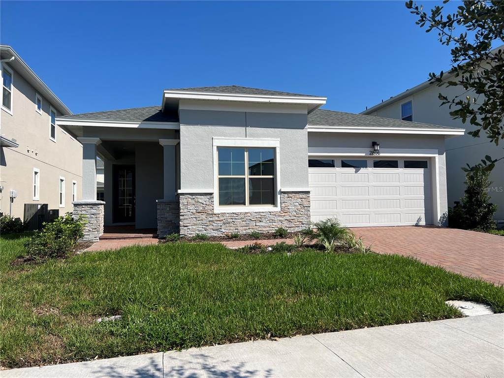 a front view of a house with a yard and garage