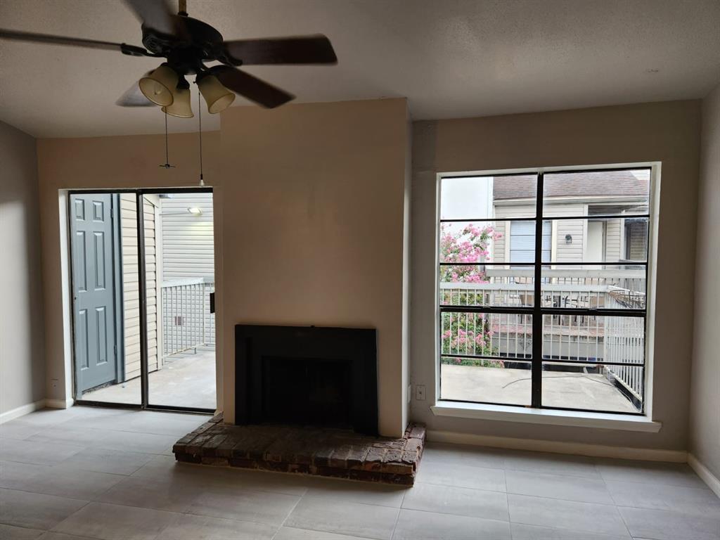 a living room with a fireplace furniture and a window