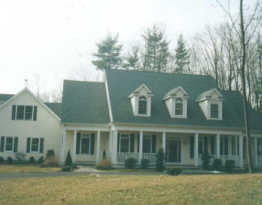 a front view of a house with windows and trees