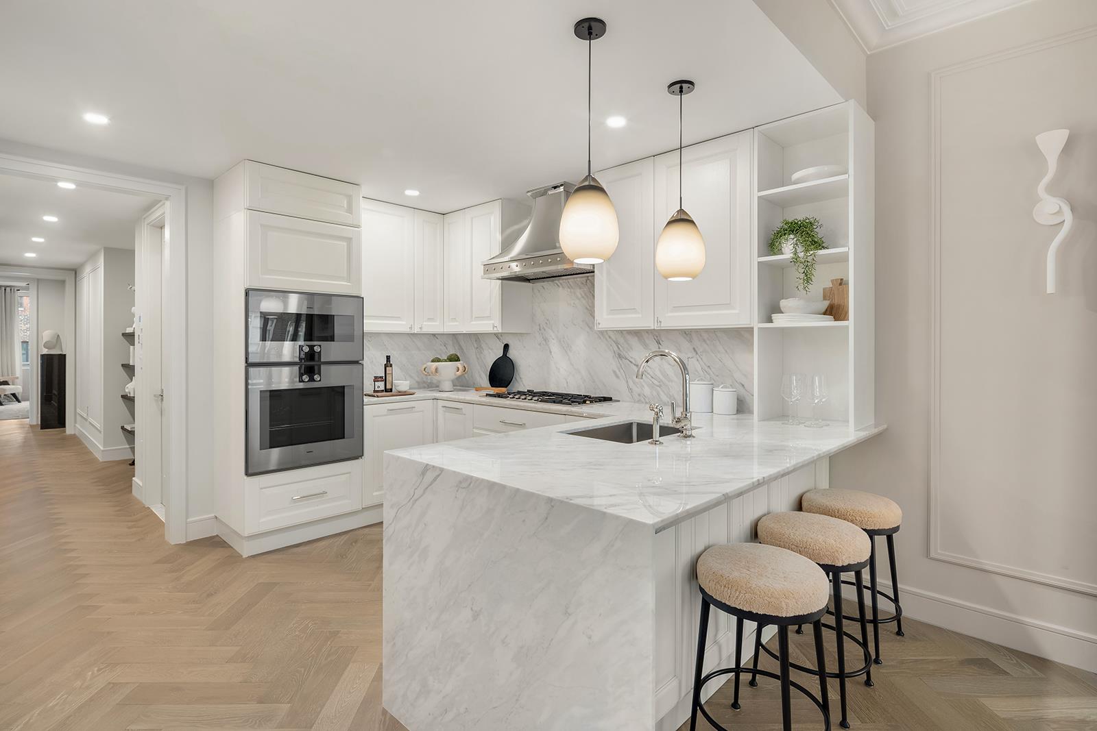 a kitchen with kitchen island a dining table and chairs