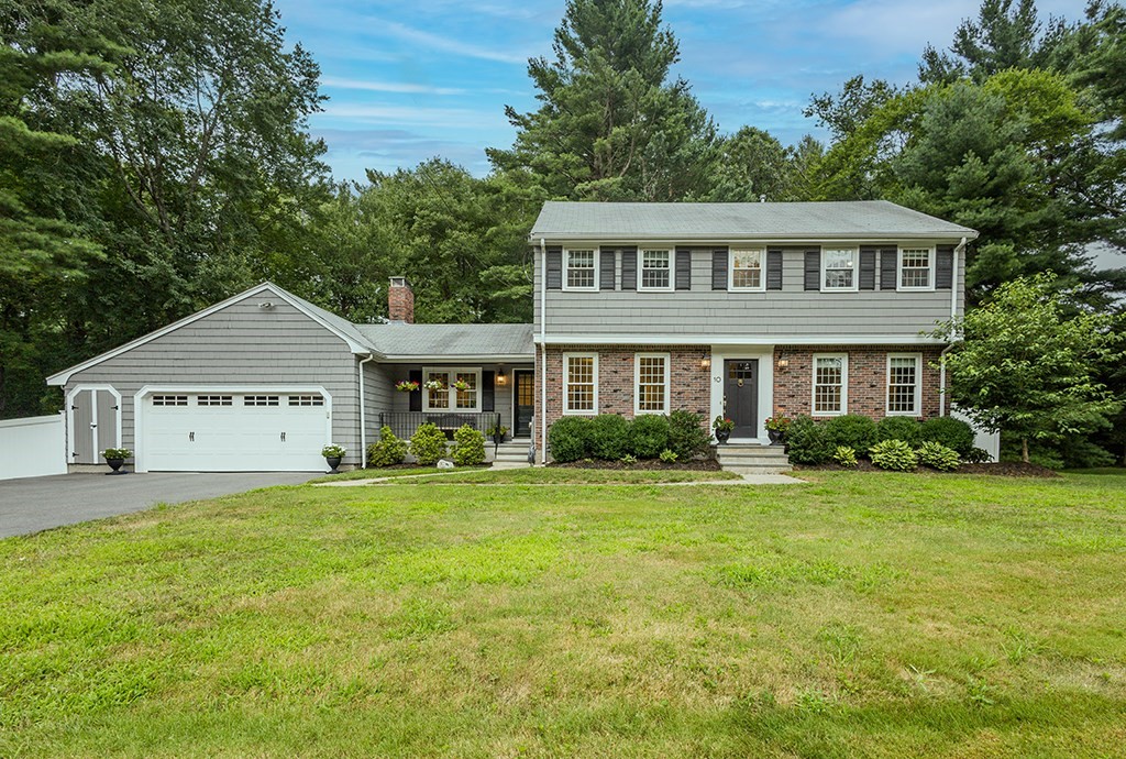 a view of a house with a big yard and large trees