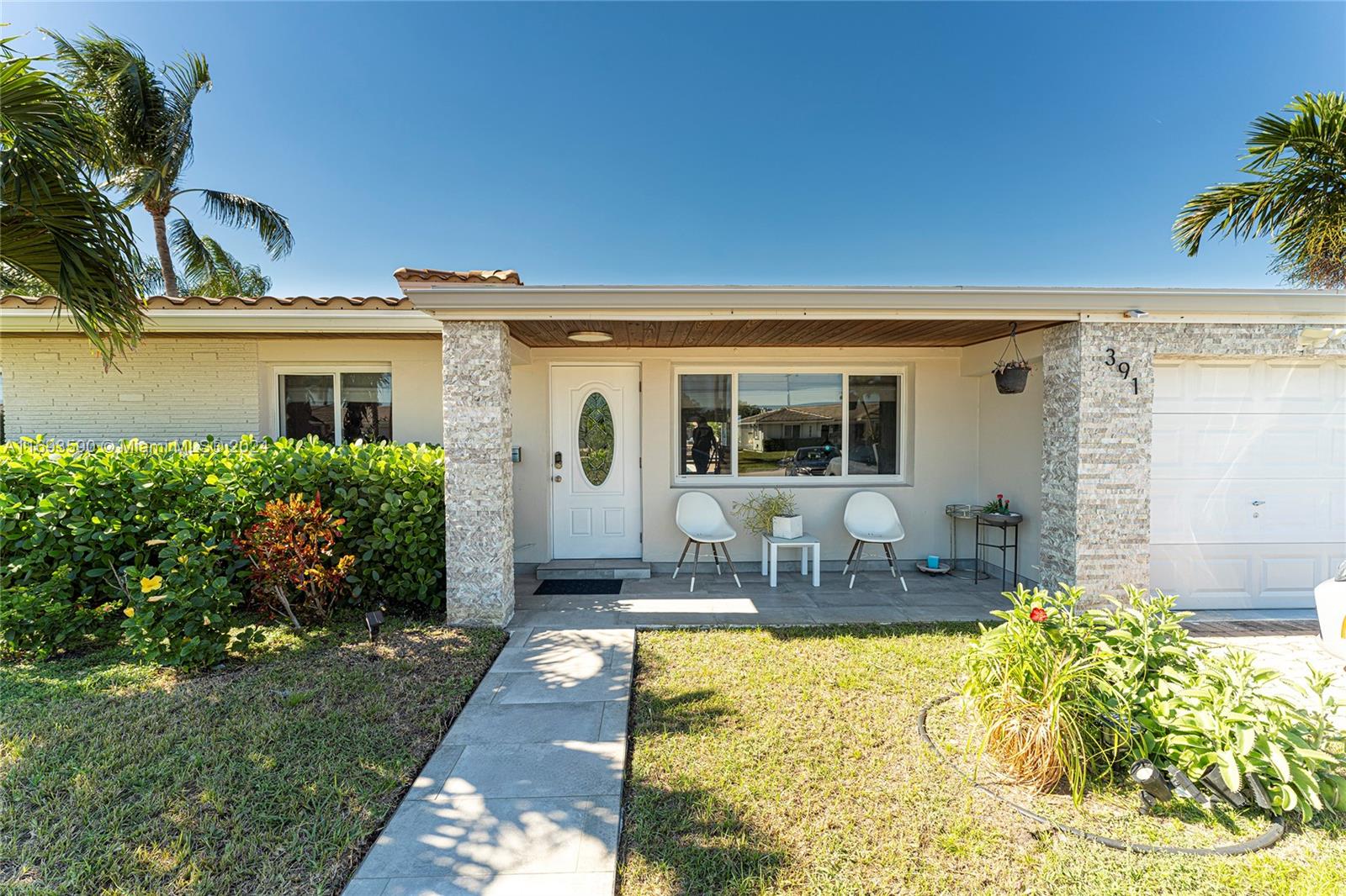 a front view of house with outdoor seating