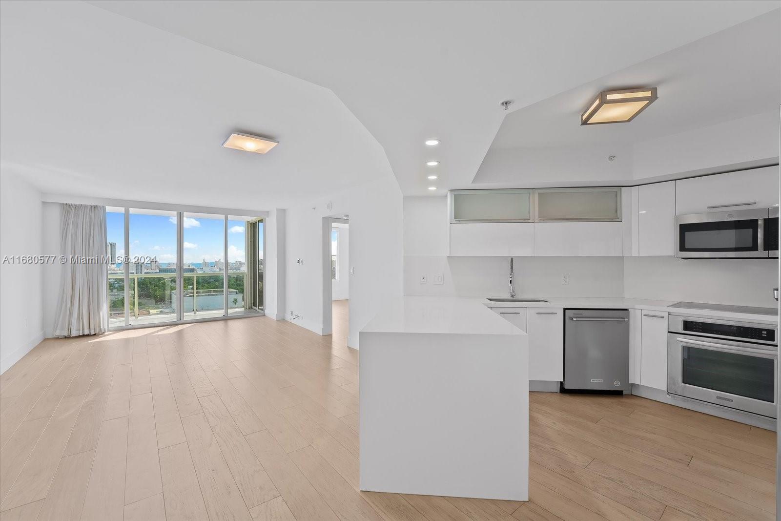 a view of a kitchen with stove and cabinets