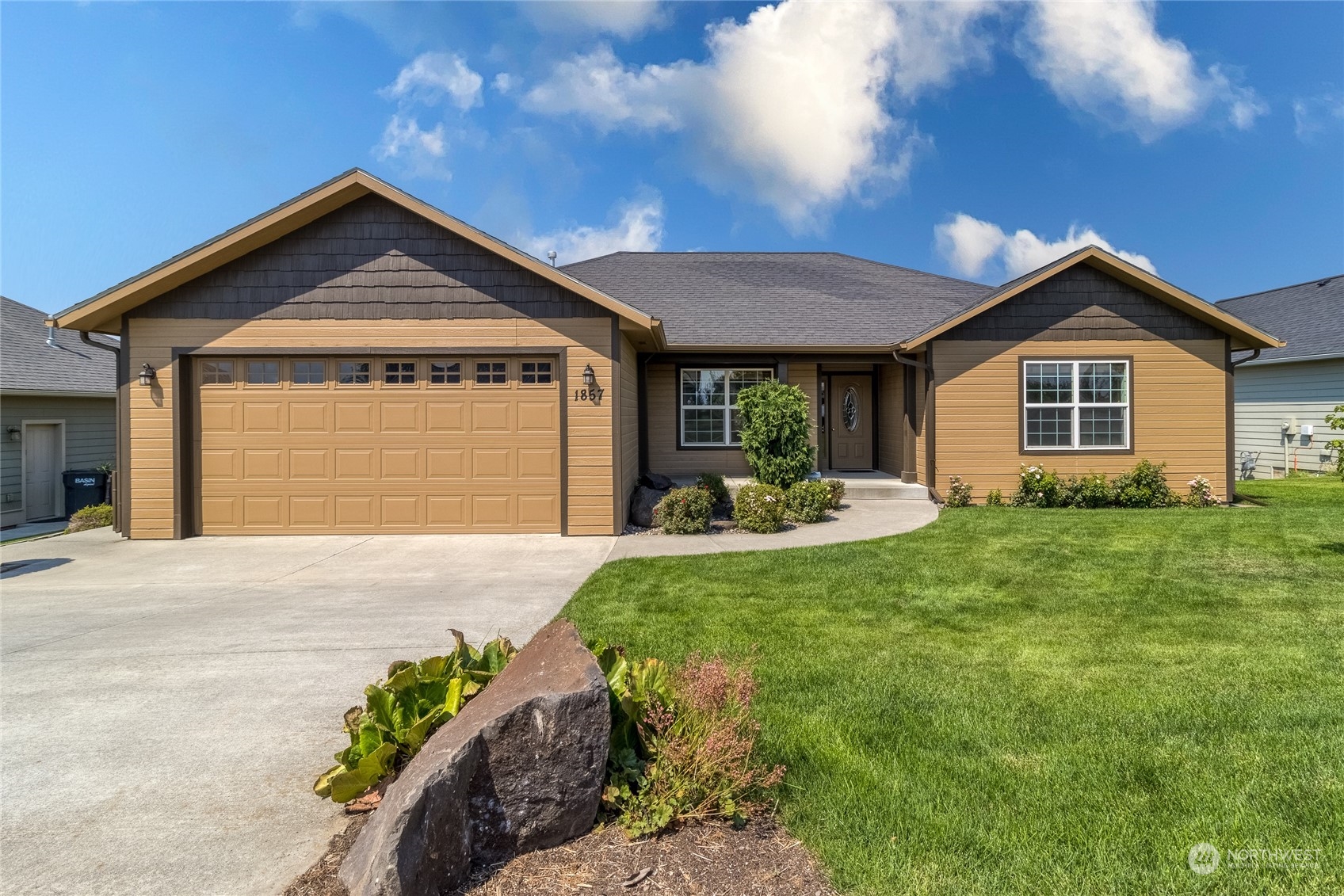 a front view of a house with a yard and garage