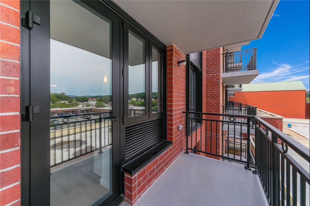 a view of balcony with floor to ceiling window