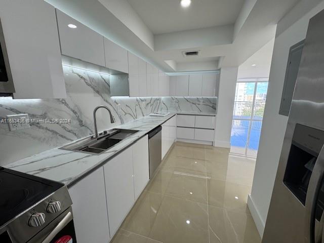 a kitchen with granite countertop a sink and a stove top oven