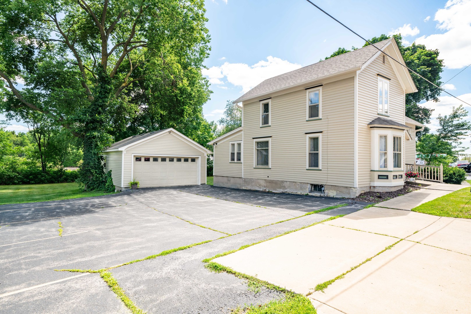 a view of a house with a backyard and a garage