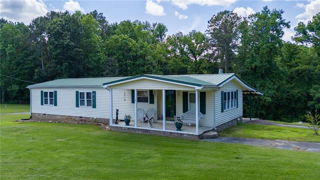 a view of a house with a yard deck and a garden