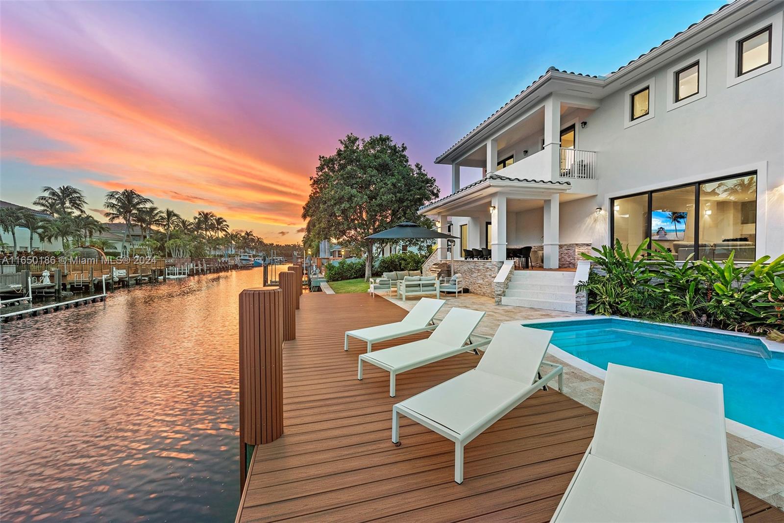 a view of a house with pool and chairs