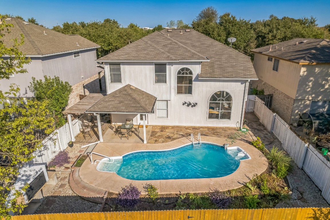 a view of a house with a backyard and garden