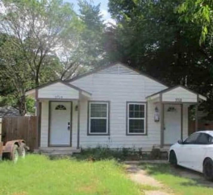 a front view of a house with a yard garage and outdoor seating