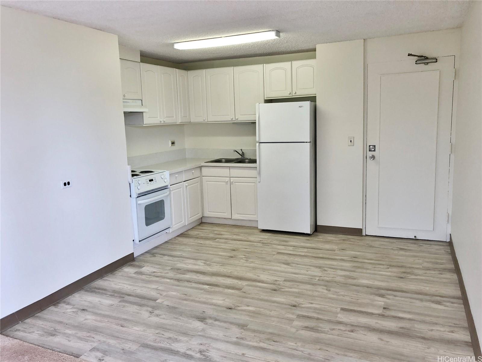 a kitchen with white cabinets and white appliances