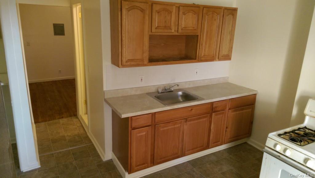 Spacious eat-in kitchen with stainless refrigerator.