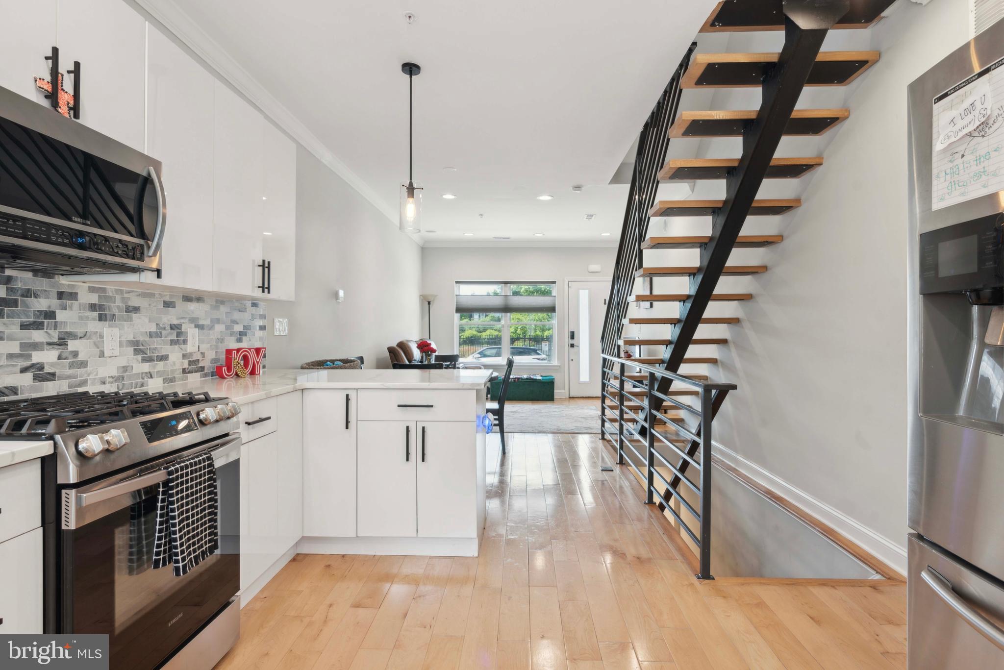 a kitchen with white cabinets and appliances