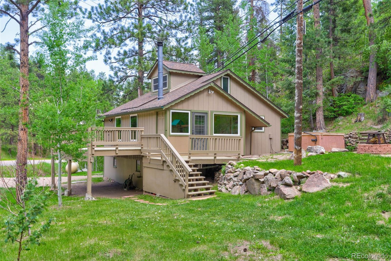 a front view of a house with a garden and trees