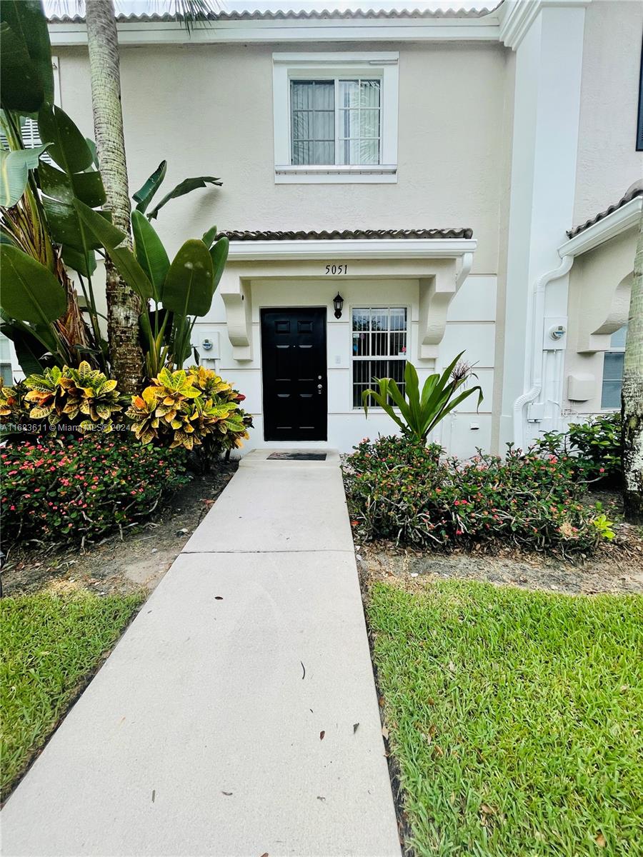 a front view of a house with garden