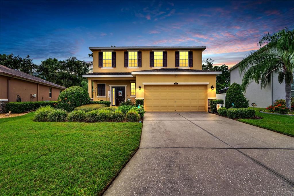 a front view of a house with a yard and garage