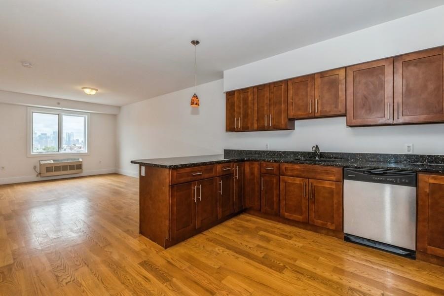 a kitchen with granite countertop wooden cabinets and white appliances