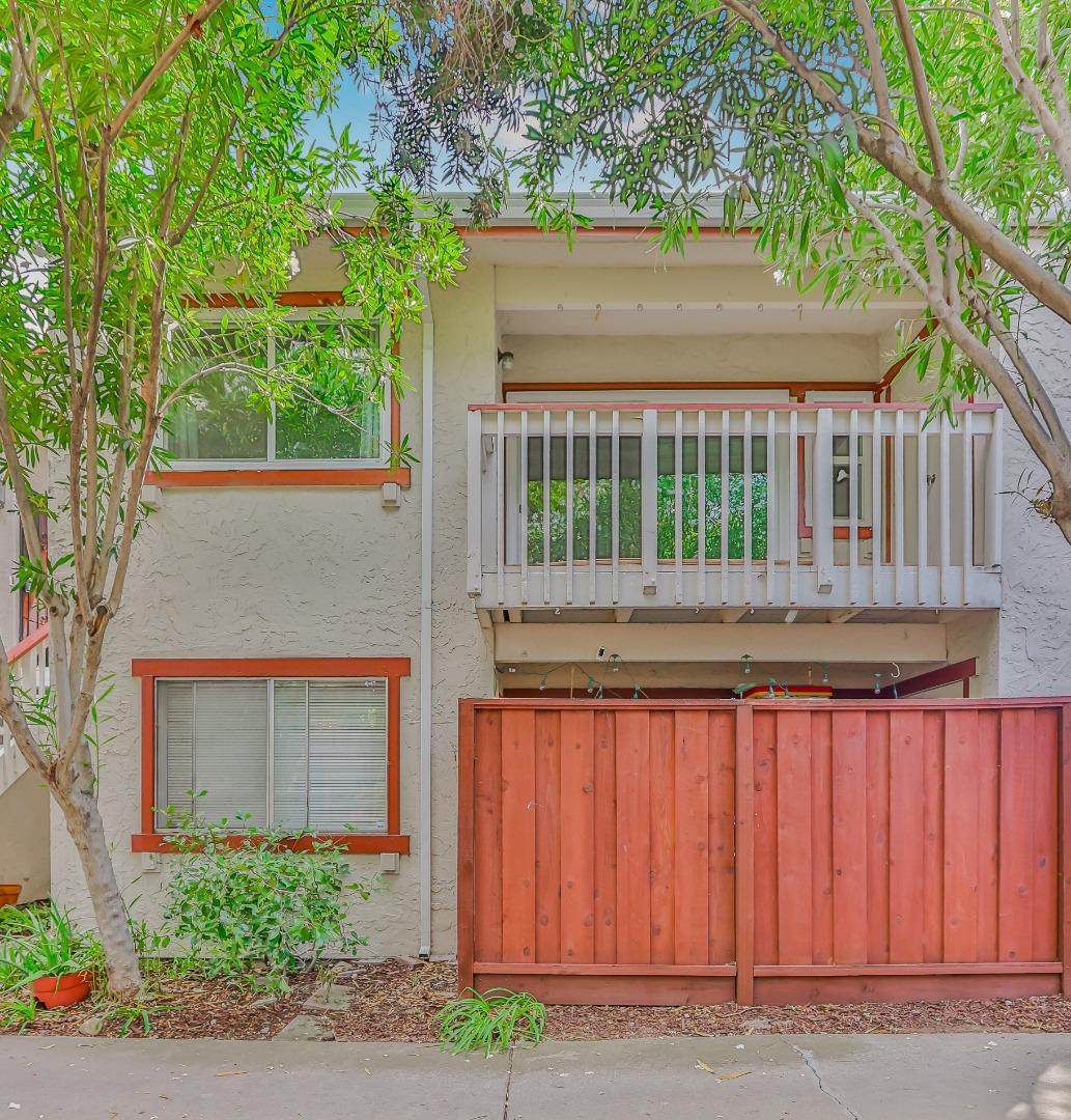 front view of house with a yard and potted plants