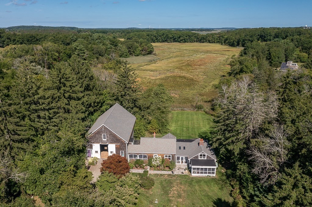 an aerial view of a house with a yard and lake view