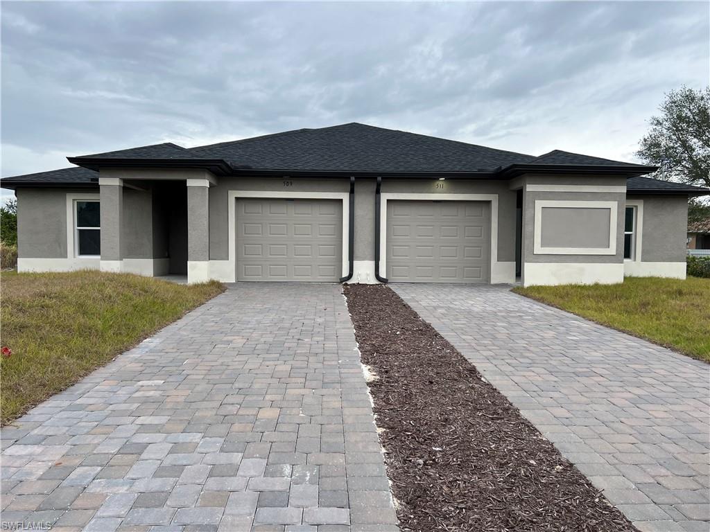 a front view of a house with a yard and garage