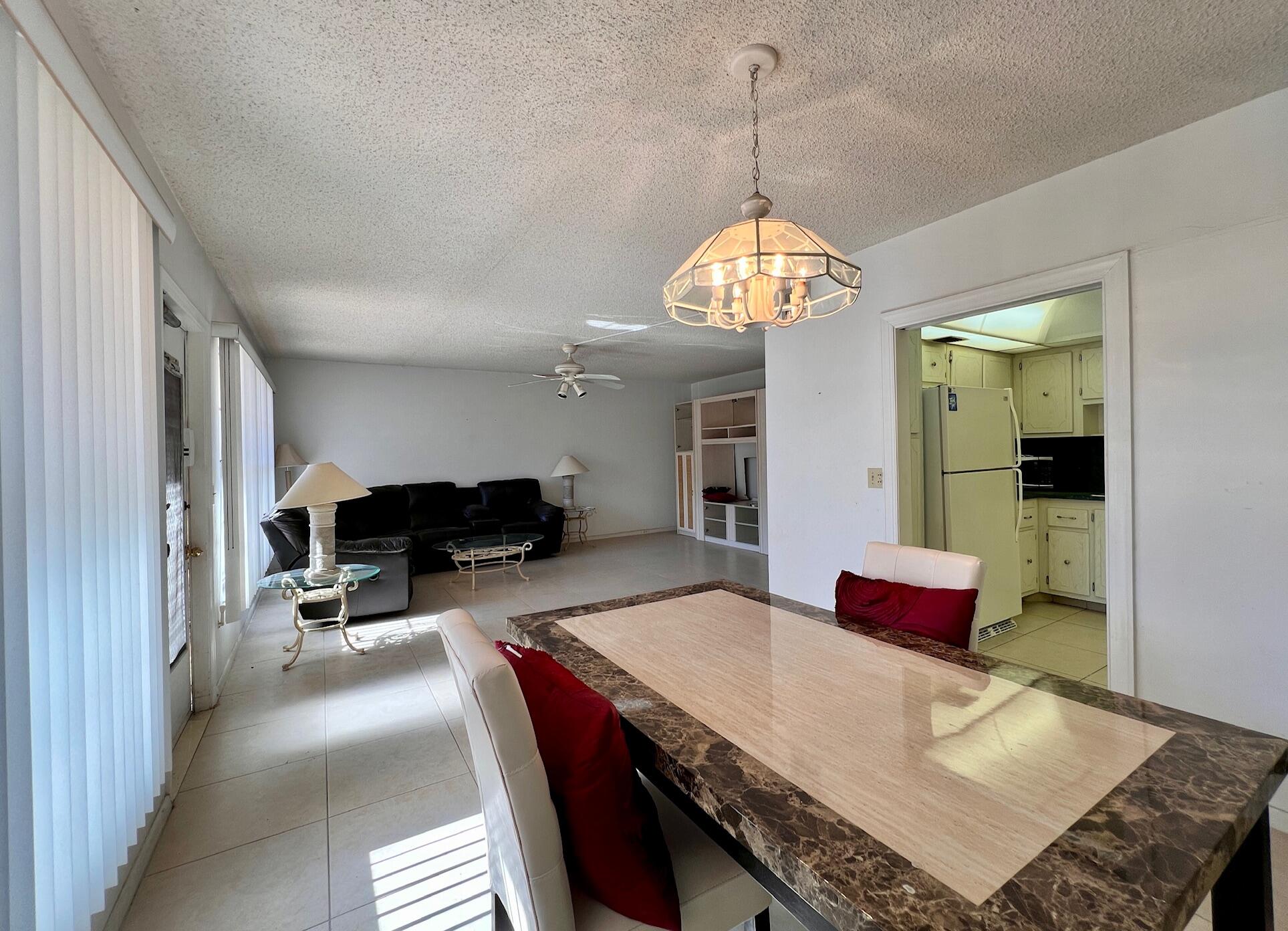 a view of a dining room and kitchen with a table chairs a workspace