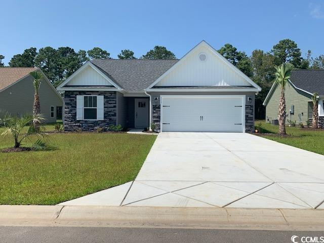 Single story home featuring a garage and a front l