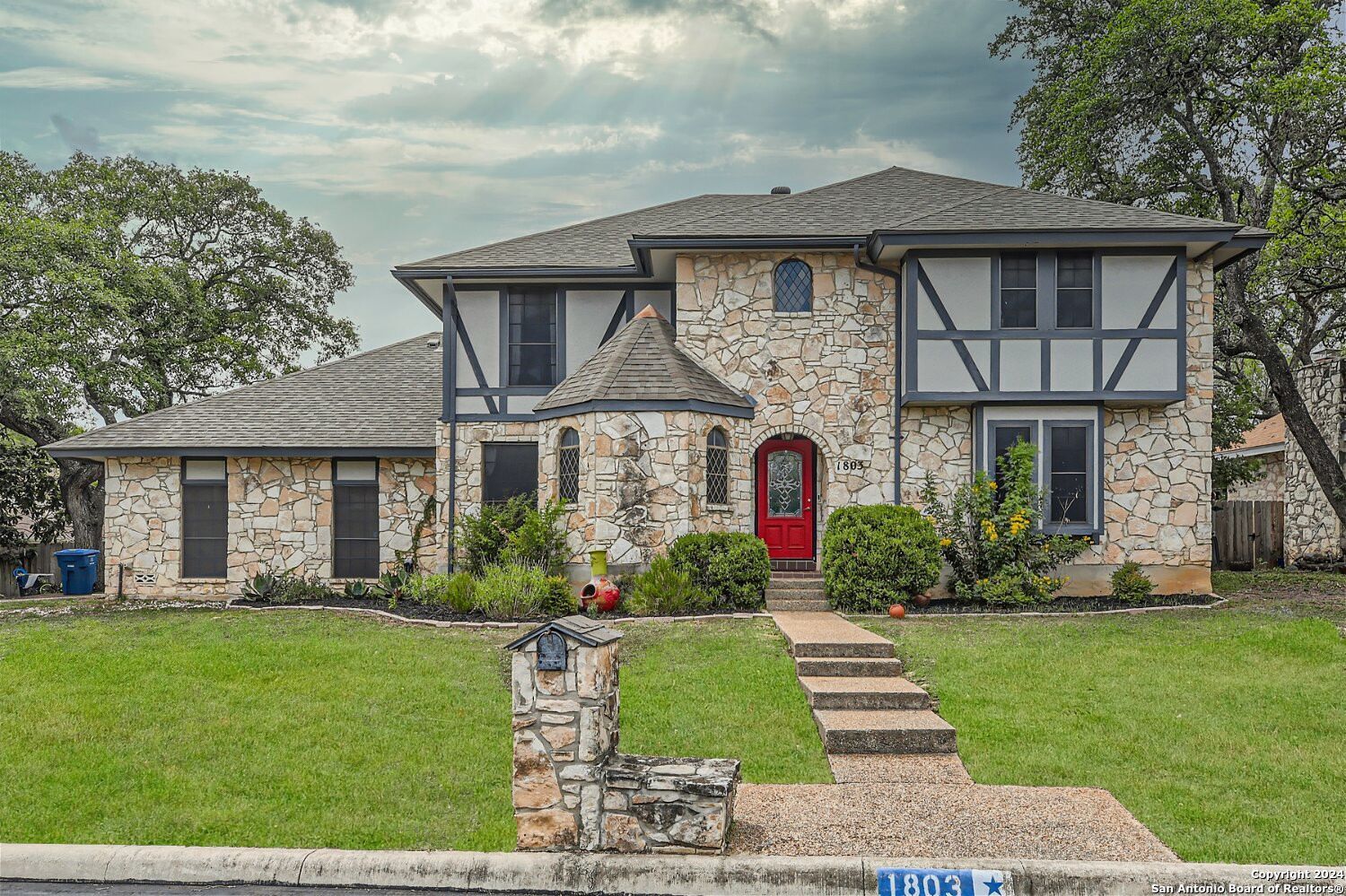 a front view of a house with a garden