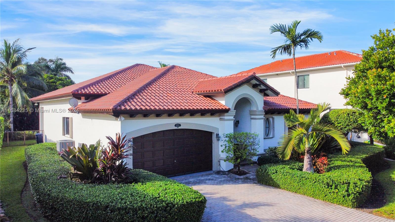 a front view of a house with a garden