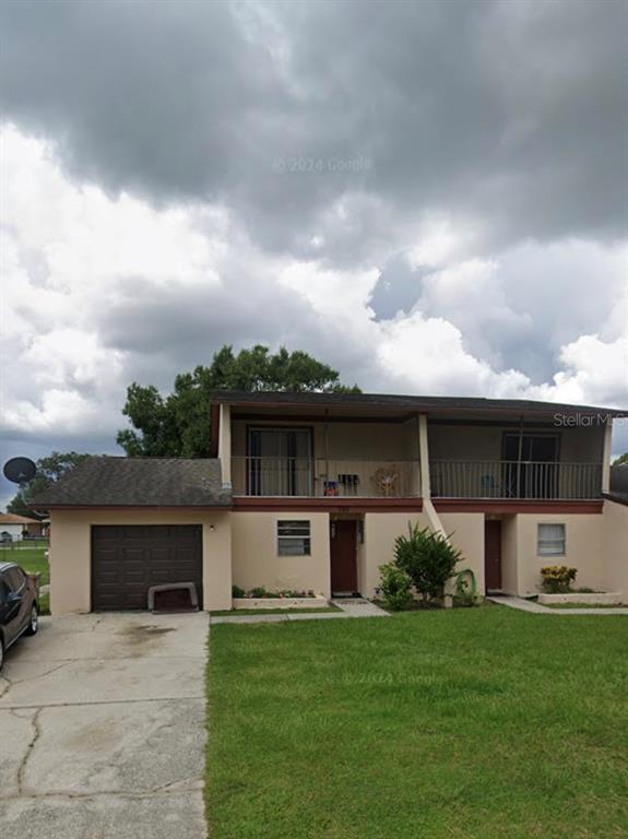 a front view of house with yard and green space