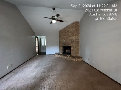 a view of an empty room with a fireplace