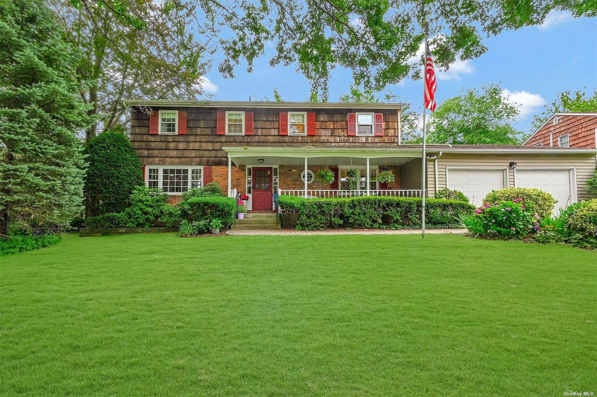 a front view of house with yard and green space