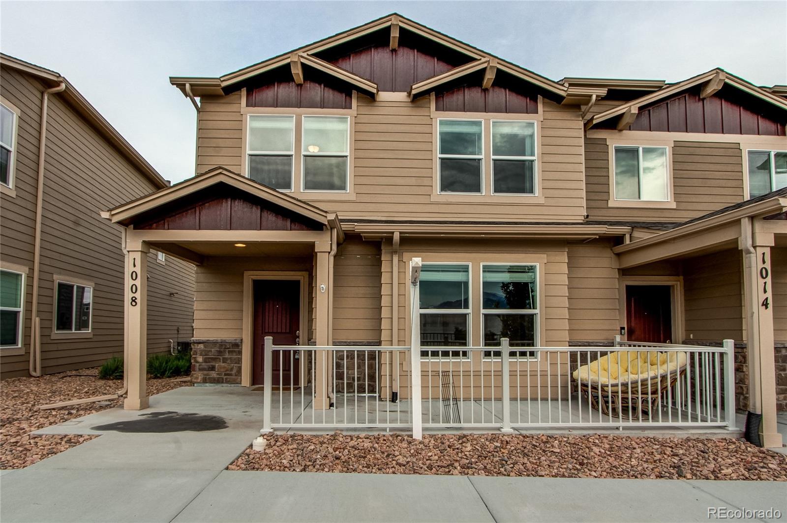 a view of a house with wooden fence